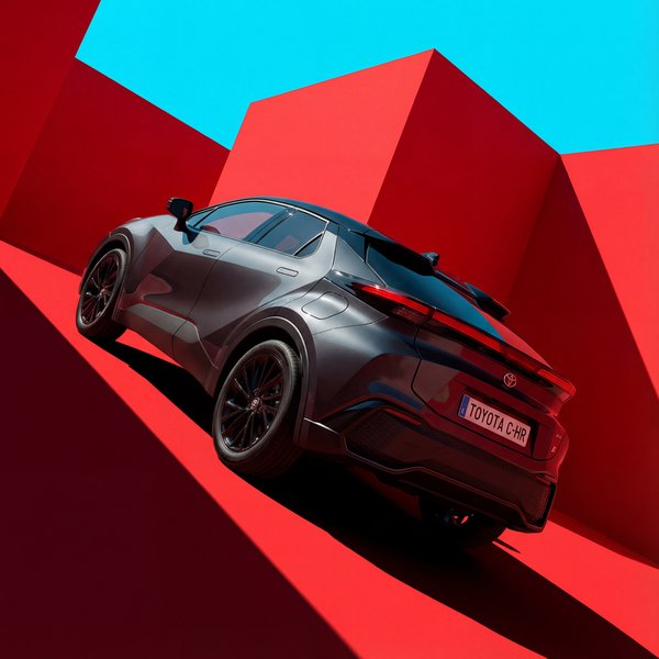 AI product photography: Toyota C-HR on bold red and cyan geometric background