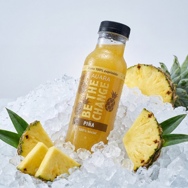 AI product photography: AUARA pineapple juice bottle on crushed ice with fresh pineapple