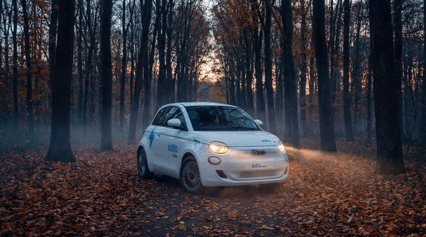 AI product photography: white Fiat 500 in misty autumn forest atmospheric shot